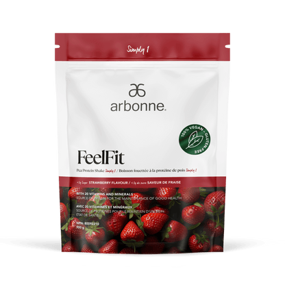 Arbonne FeelFit vegan pea protein powder in strawberry flavor, featuring vibrant strawberries on the packaging with a prominent green vegan certification seal, set against a white backdrop.