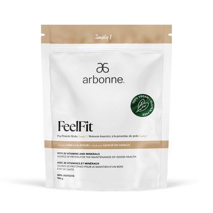 Elegant white and gold packaging of Arbonne FeelFit vegan pea protein powder with a vanilla flavor, adorned with a green vegan certification seal, presented on a clean white surface.