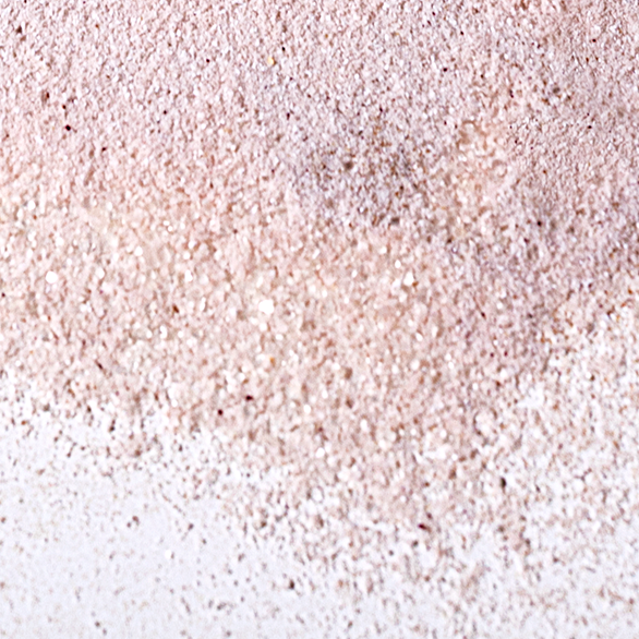 Close-up texture of a natural pink mineral powder with a subtle shimmer.